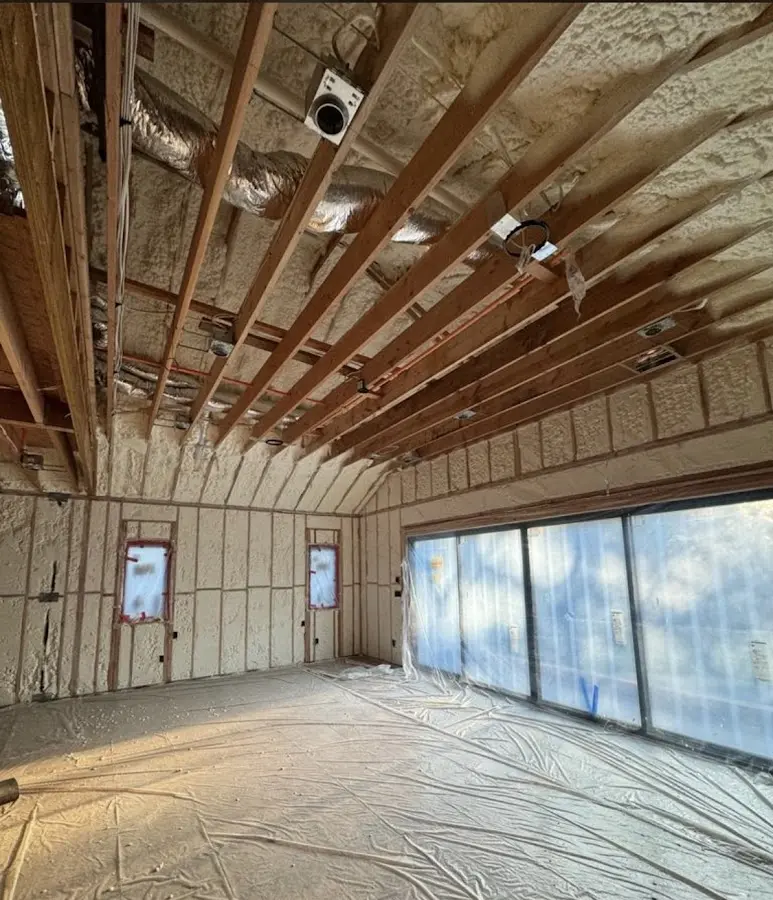 Interior walls and ceiling insulated with spray foam during new construction in Hamilton